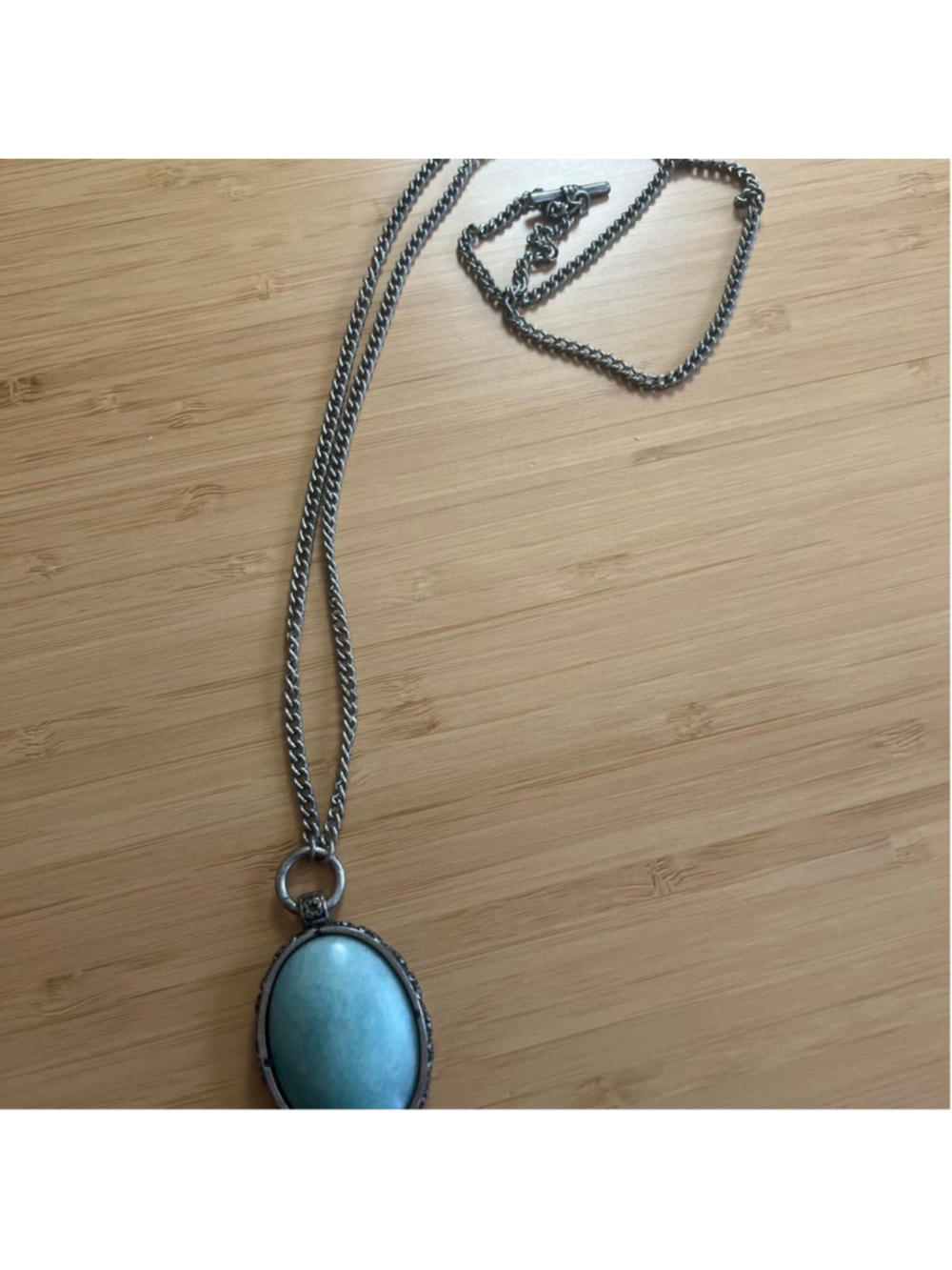 Long silver necklace with large turquoise stone